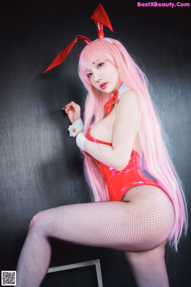 A woman with long pink hair wearing a bunny costume.