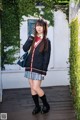 A young woman in a school uniform posing for a picture.